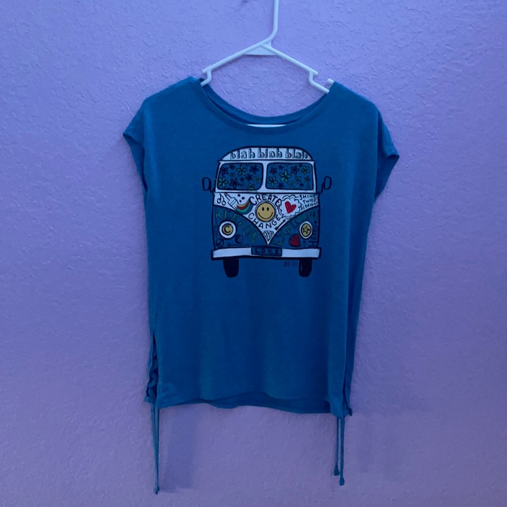 A blue shirt with a colorful “bus”